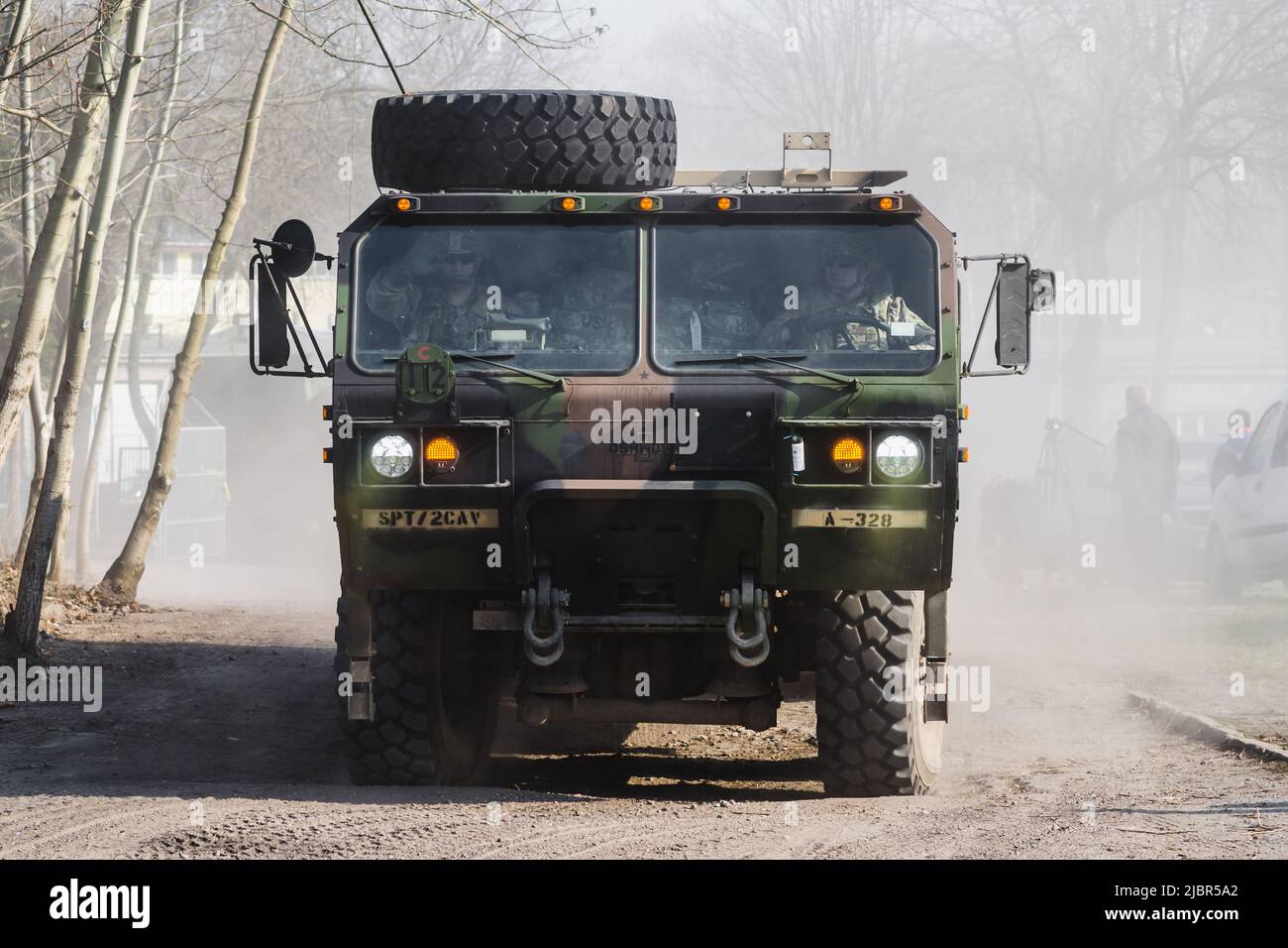 Lublin, Poland - March 25, 2015: United States Army Oshkosh Logistics Vehicle System passing city streets Stock Photo