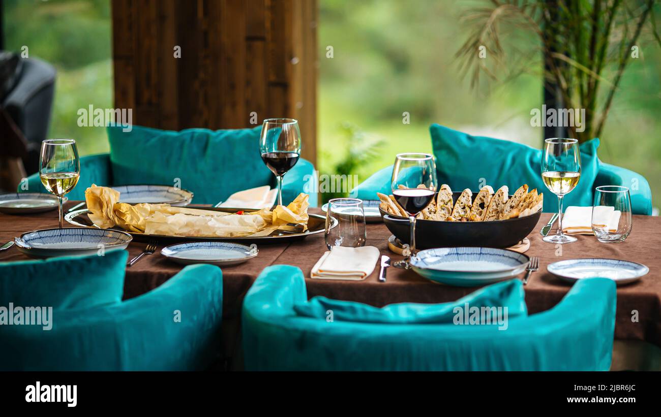 Served restaurant table with drinks and food Stock Photo