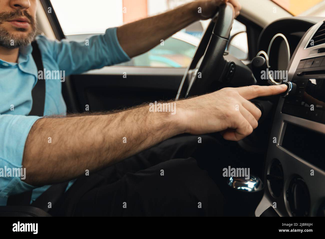 Male Driver Pushing Control Button On Panel Driving Car, Cropped Stock Photo
