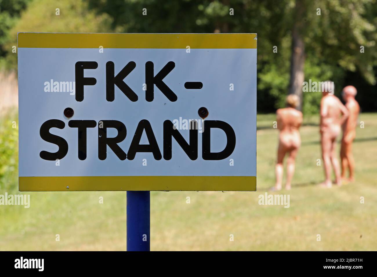 Halberstadt, Germany. 02nd June, 2022. Bathers stand in the nudist area at  Halberstadt Lake in the Harz Mountains. The 