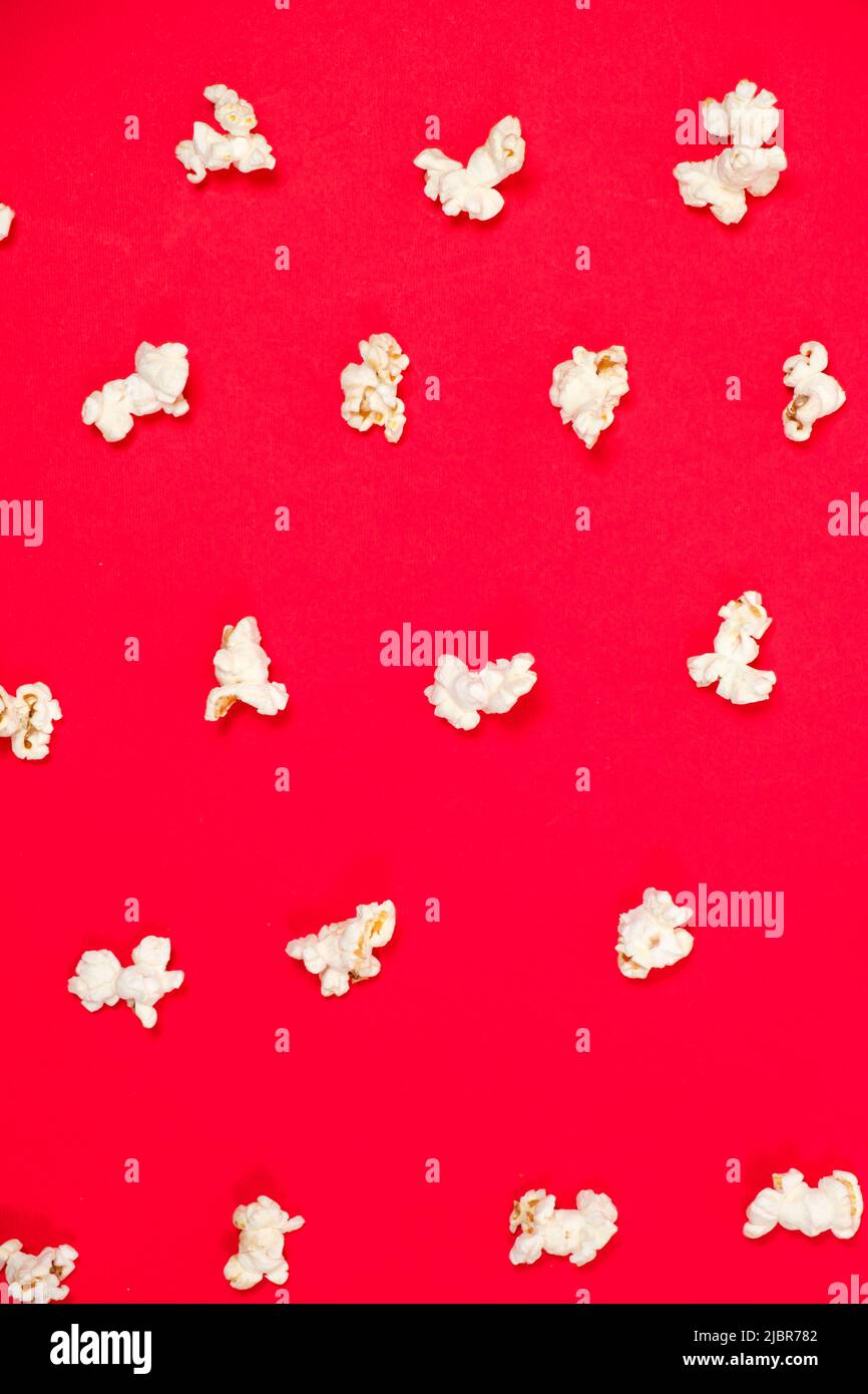 Popcorn on a red background, close-up view from above Stock Photo