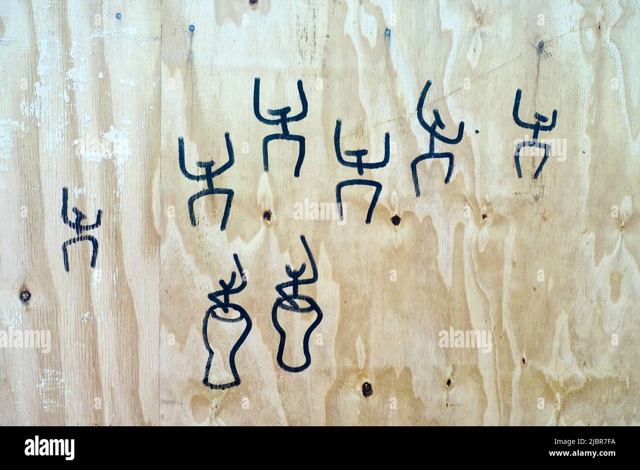 Drawn funny figures on a site fence Stock Photo