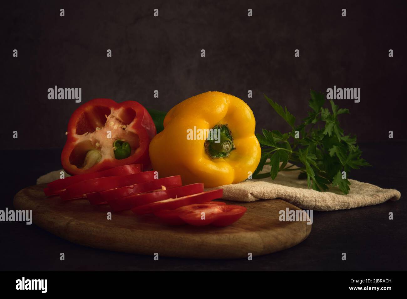 yellow green and red peppers on the cutting board Stock Photo - Alamy