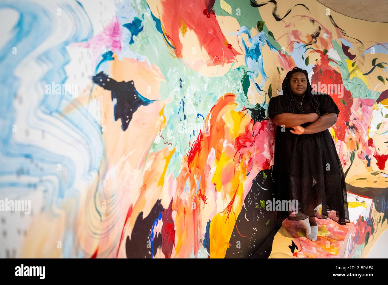 https://c8.alamy.com/comp/2JBRAFX/london-uk-8-june-2022-painter-michaela-yearwood-dan-poses-with-her-work-let-me-hold-you-a-curved-mural-on-display-at-the-newly-opened-permanent-arts-space-for-lgbtq-artists-and-community-at-queercircle-in-north-greenwich-credit-stephen-chung-alamy-live-news-2JBRAFX.jpg