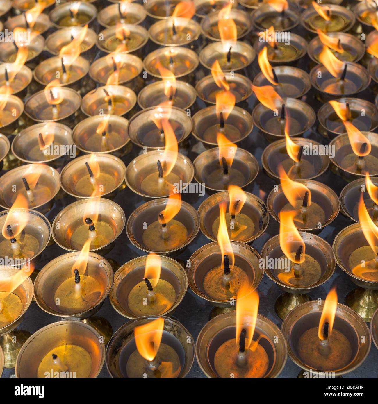 Burning prayer candles in buddhist temple Stock Photo Alamy
