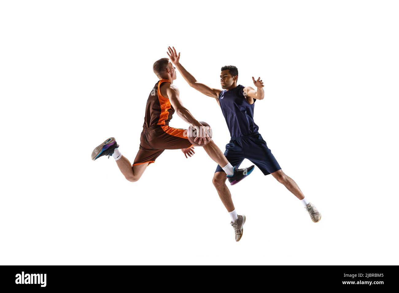 Dynamic portrait of two basketball playera in motion in a jump