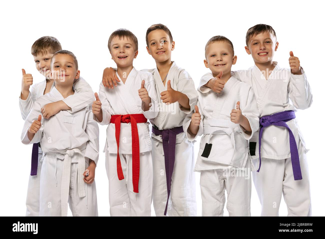 Group of happy children, beginner karate fighters in white doboks