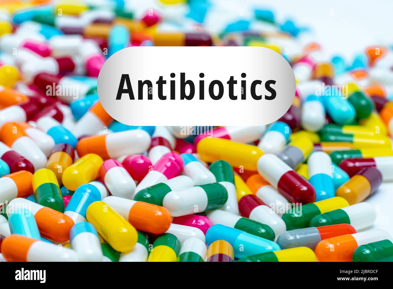 Pile of multi-colored antibiotics capsule pills. Antibiotic drug resistance concept. Prescription drugs. Superbug concept. Antibiotic drug use with re Stock Photo