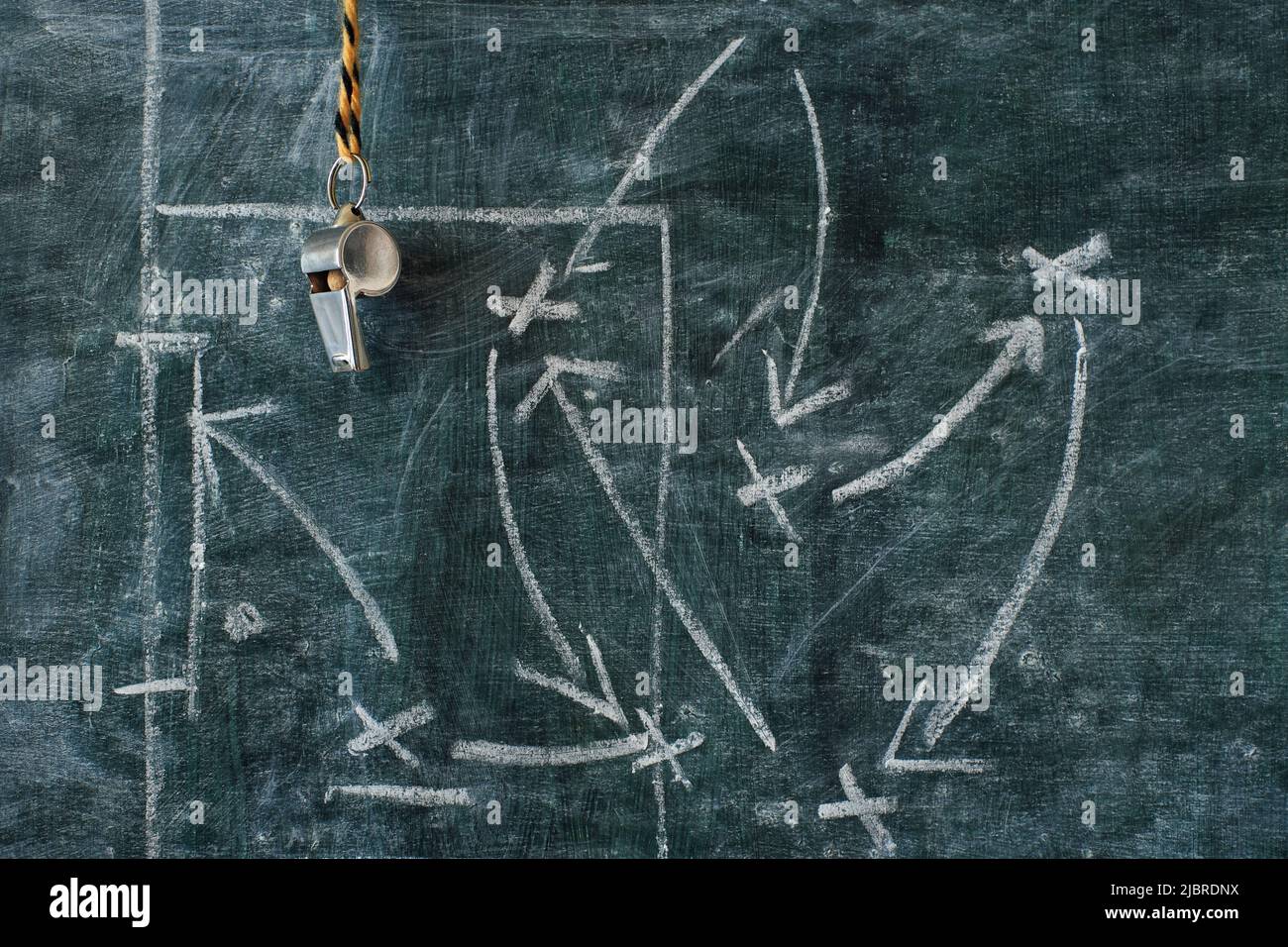 Whistle of soccer referee or trainer and soccer tactics diagram on black board. Great soccer event, soccer championship concept Stock Photo