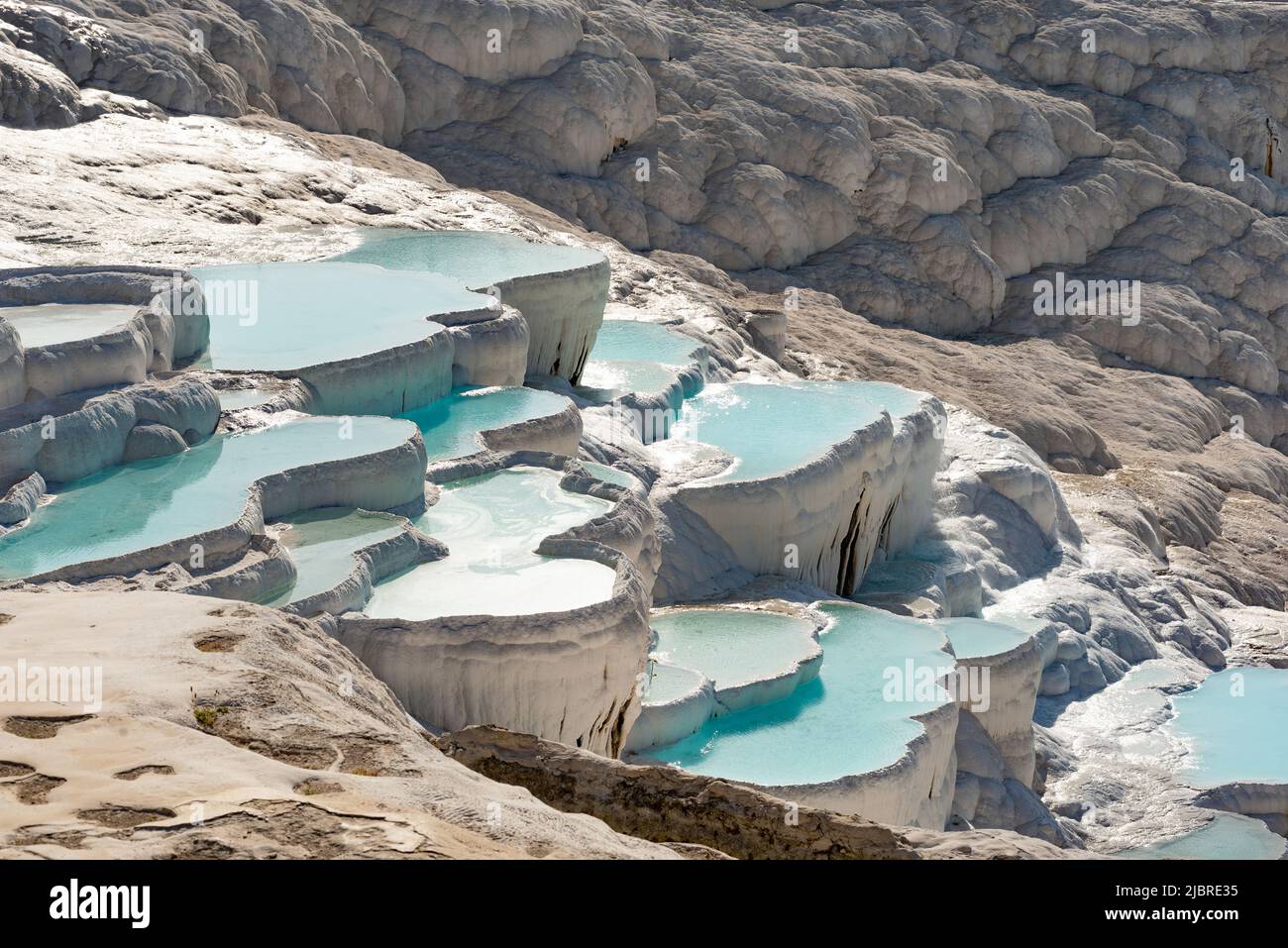 Pamukkale Travertine Terraces, amazing aqua blue pools of thermal mineral rich spring water set against a geological rock formation, world heritage si Stock Photo