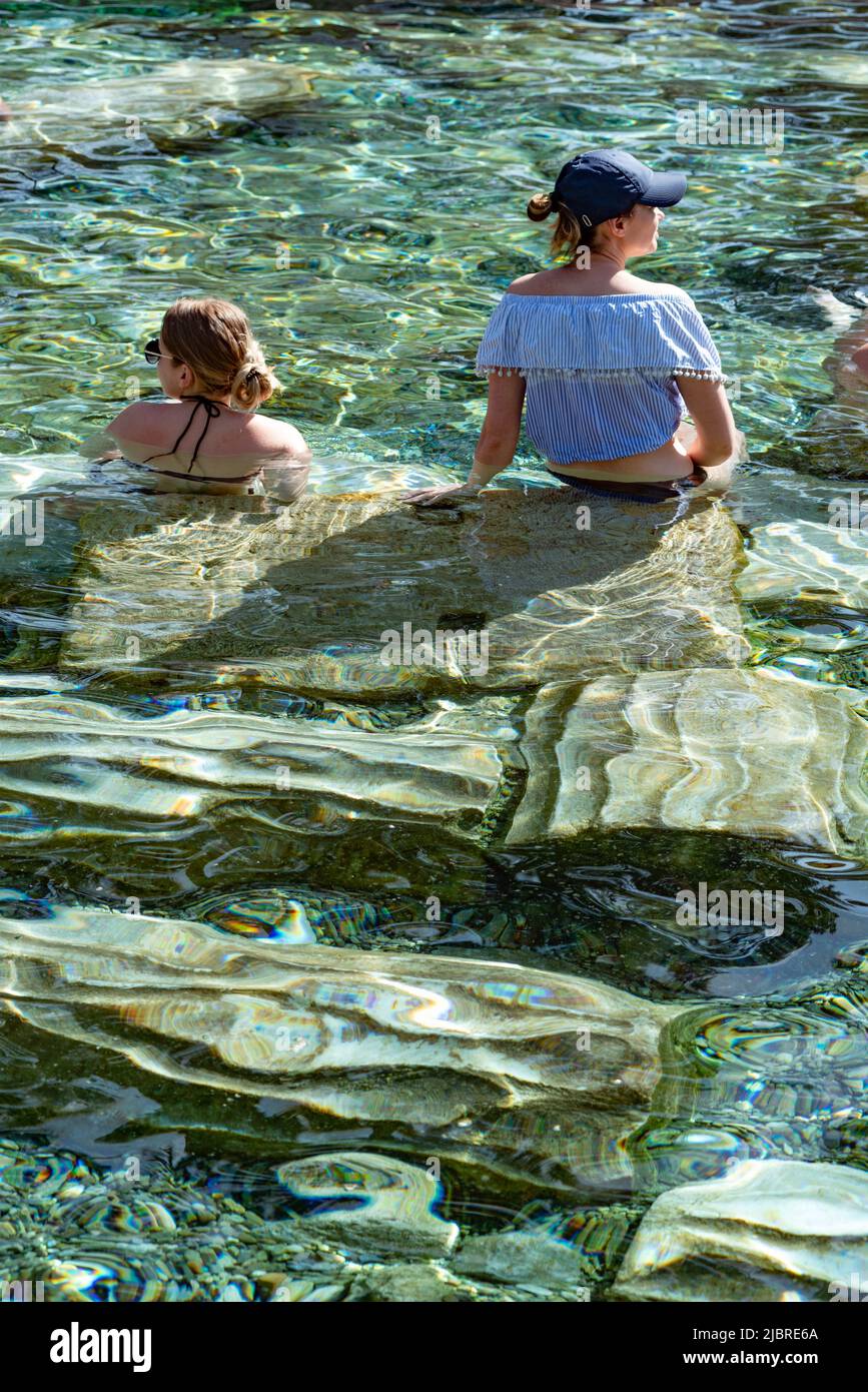 Pamukkale, Turkey, April 25th 2020  Foreign tourists enjoy the healing properties of thermal waters among fallen Roman columns in Cleopatra’s Antique Stock Photo