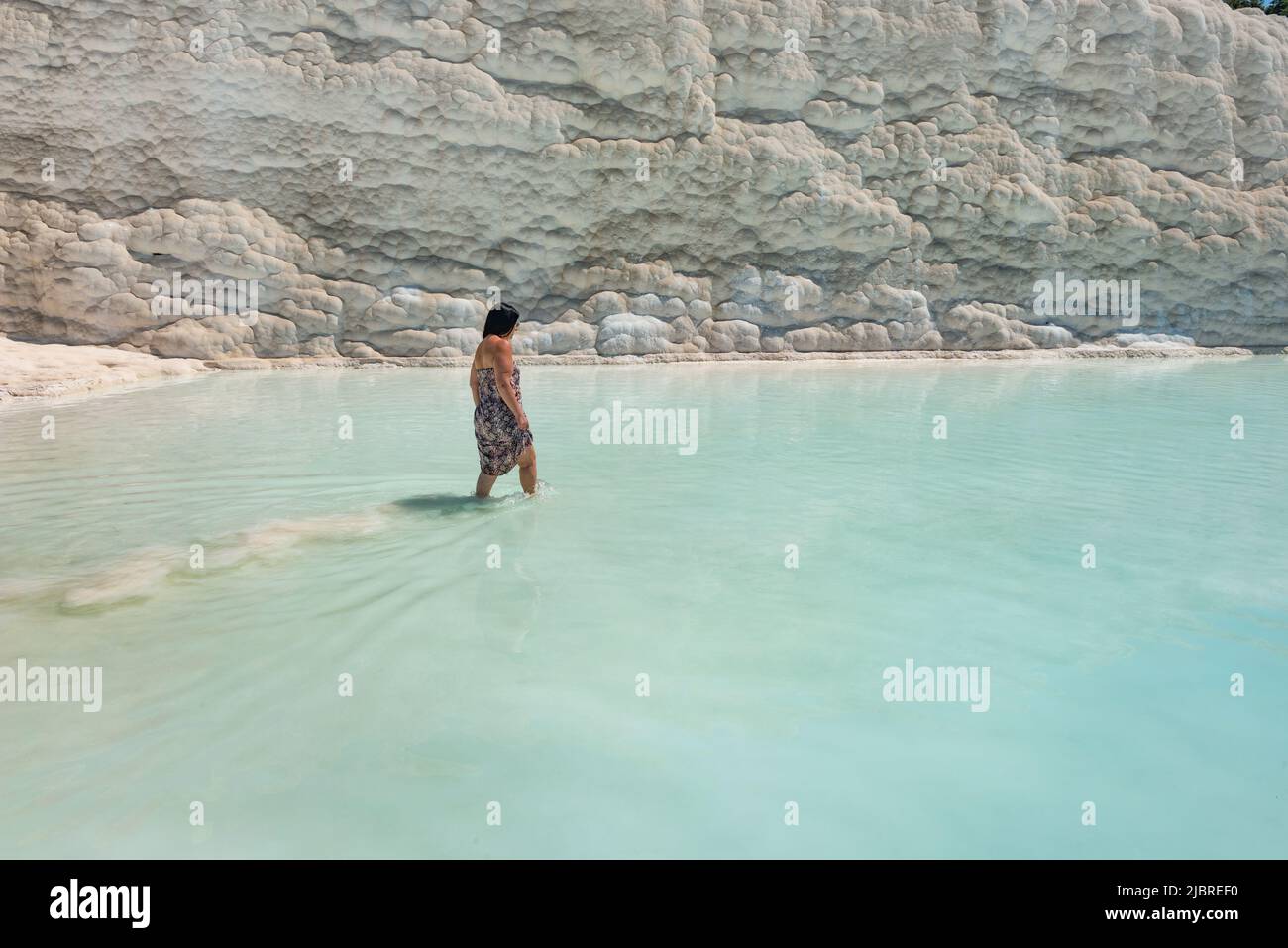 Pamakkule, Turkey, April 25th 2020 A tourist soak her feet in the thermal waters of the Travertine Terraces of Pamukkale, the mineral rich thermal wat Stock Photo