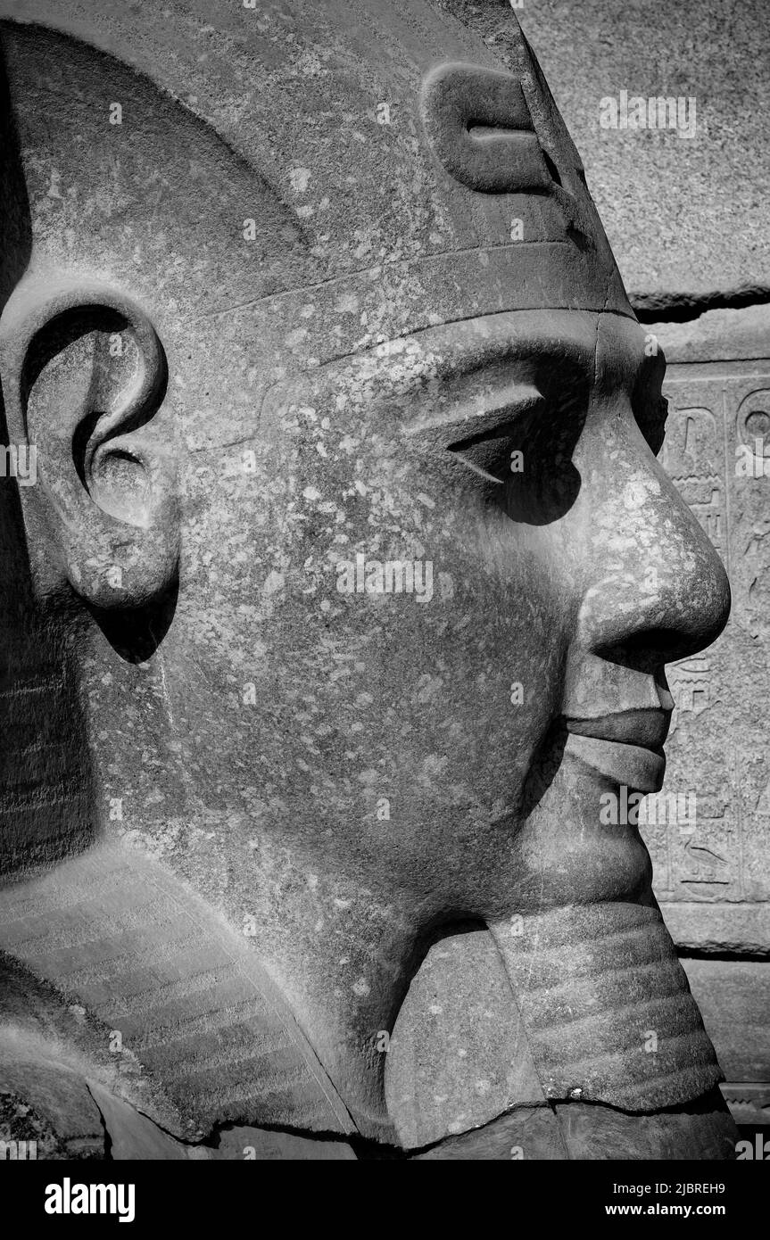 Stone Pharaonic Head in black and white  Pharaonic inscriptions at the ancient Egyptian ruins beside the Nile at Luxor, Egypt. Stock Photo