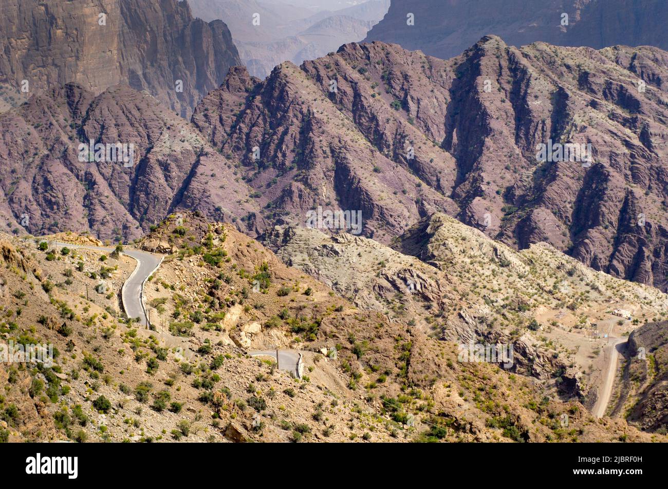 Dramatic Omani mountains called Jebel Akhdar of the Hajar mountain range, the harsh interior of Oman, home of traditional rose harvesting and fruit fa Stock Photo