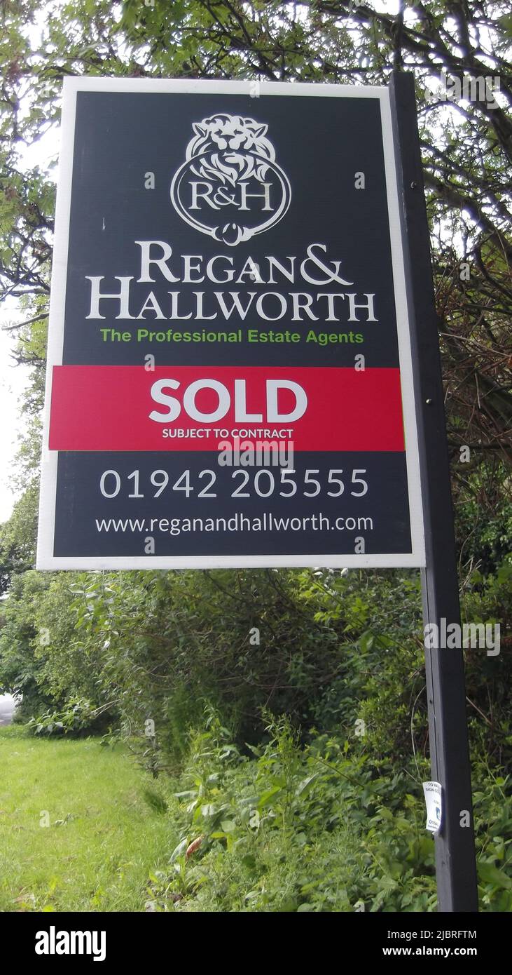 Property sold sign by Regan and Hallworth, West Lancashire, UK Stock Photo