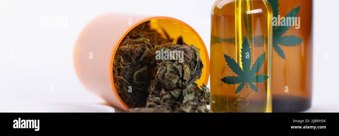 Dry marijuana buds extract oil and spray in plastic bottles Stock Photo