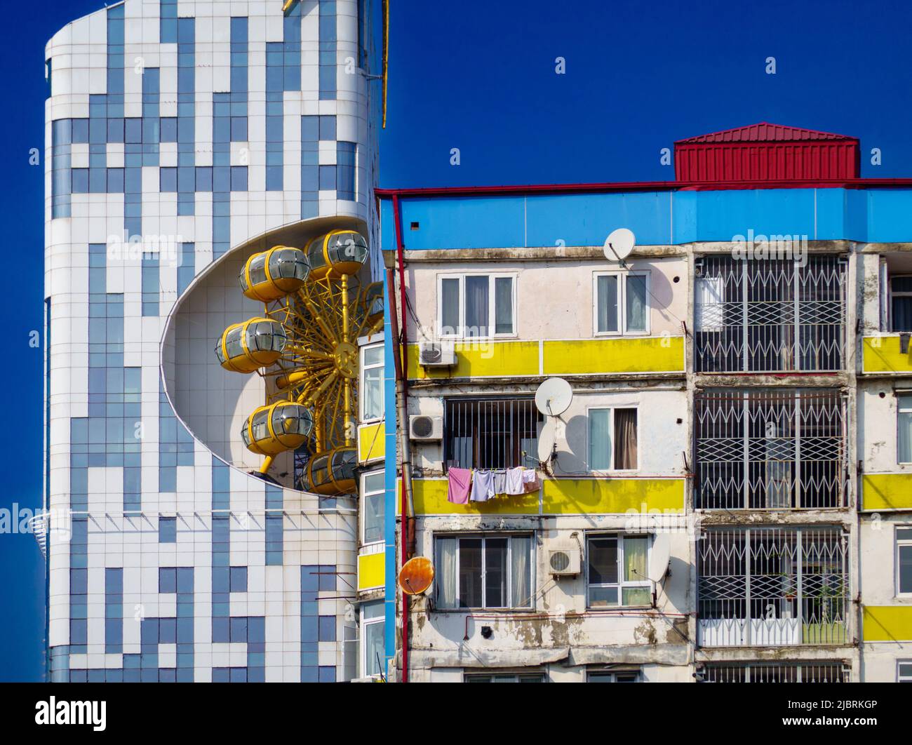 Tower with Ferris wheel near apartment building Stock Photo Alamy
