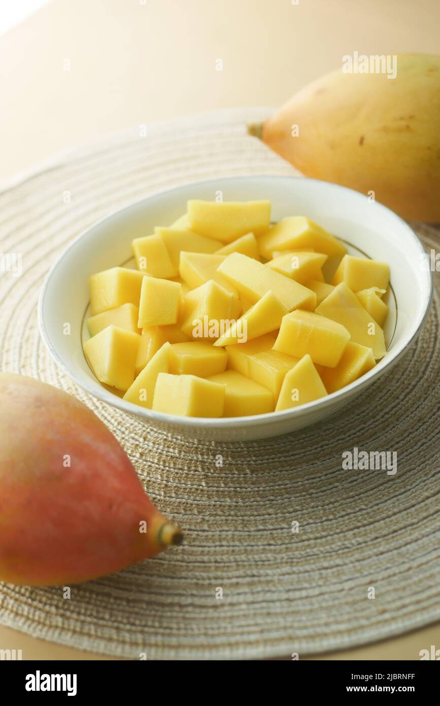 yellow ripe cut mango in a bowl top down  Stock Photo