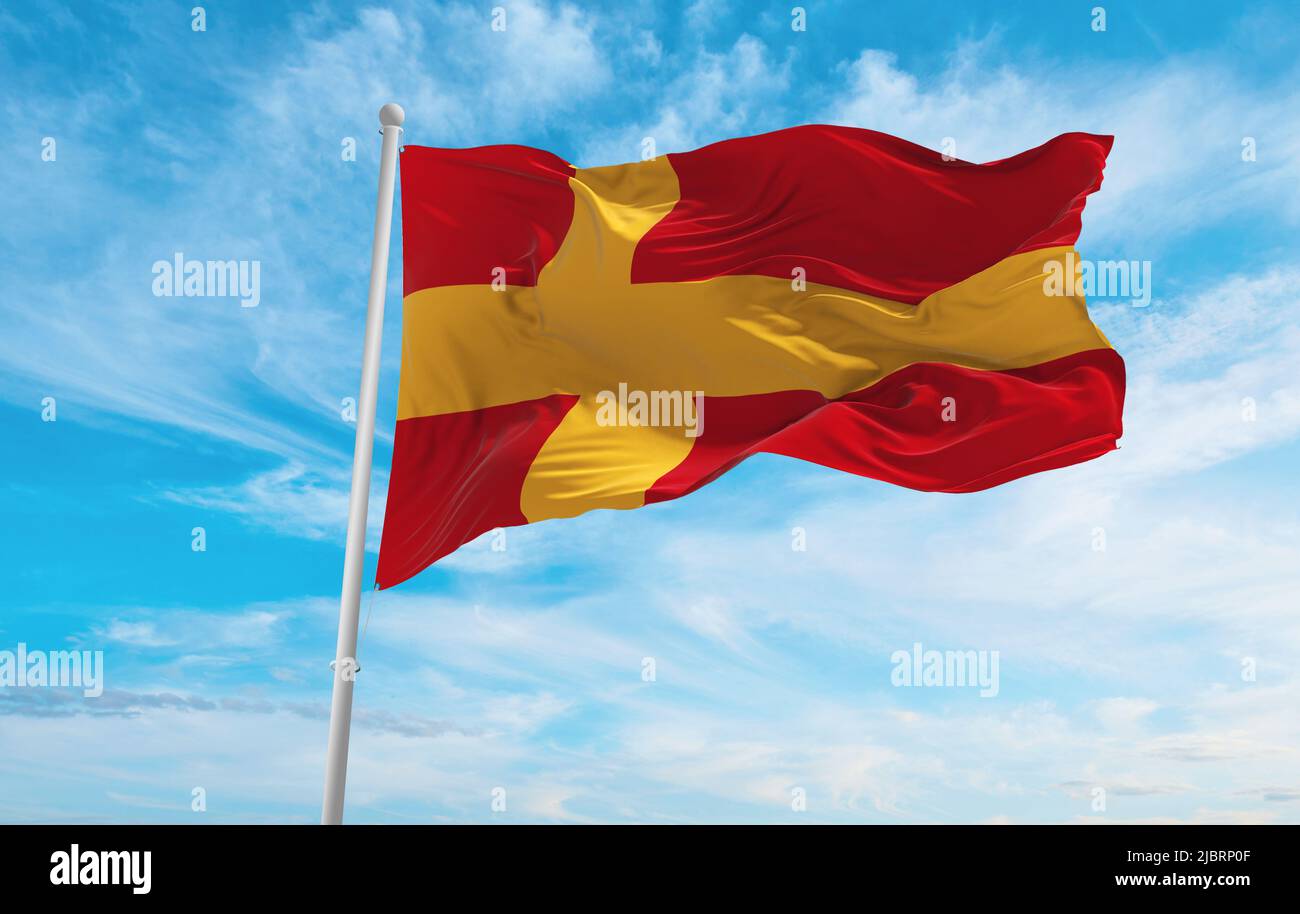 official flag of Swedish speaking Finns , Finland at cloudy sky background on sunset, panoramic view. Finnish travel and patriot concept. copy space f Stock Photo