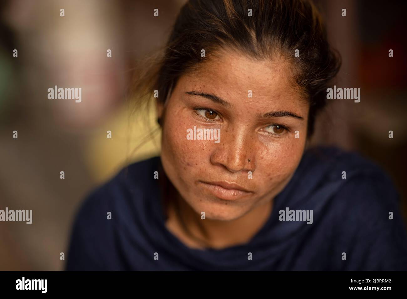 Close-up of a slum young woman looking sad  Stock Photo