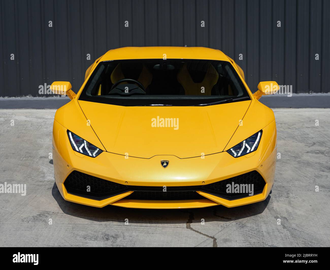 Banana Yellow Lamborghini Huracan behind garage Stock Photo