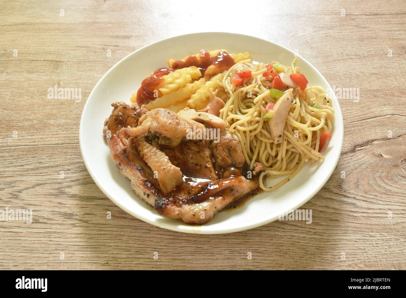 grilled chicken black pepper steak dressing spicy sauce with French fries and fried spaghetti
