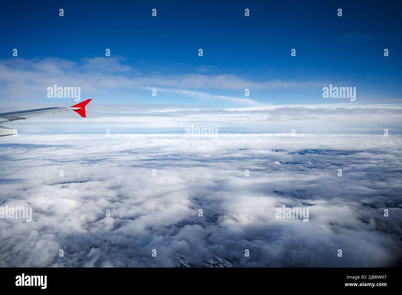 Aircraft wing above beautiful clouds and blue sky Stock Photo - Alamy