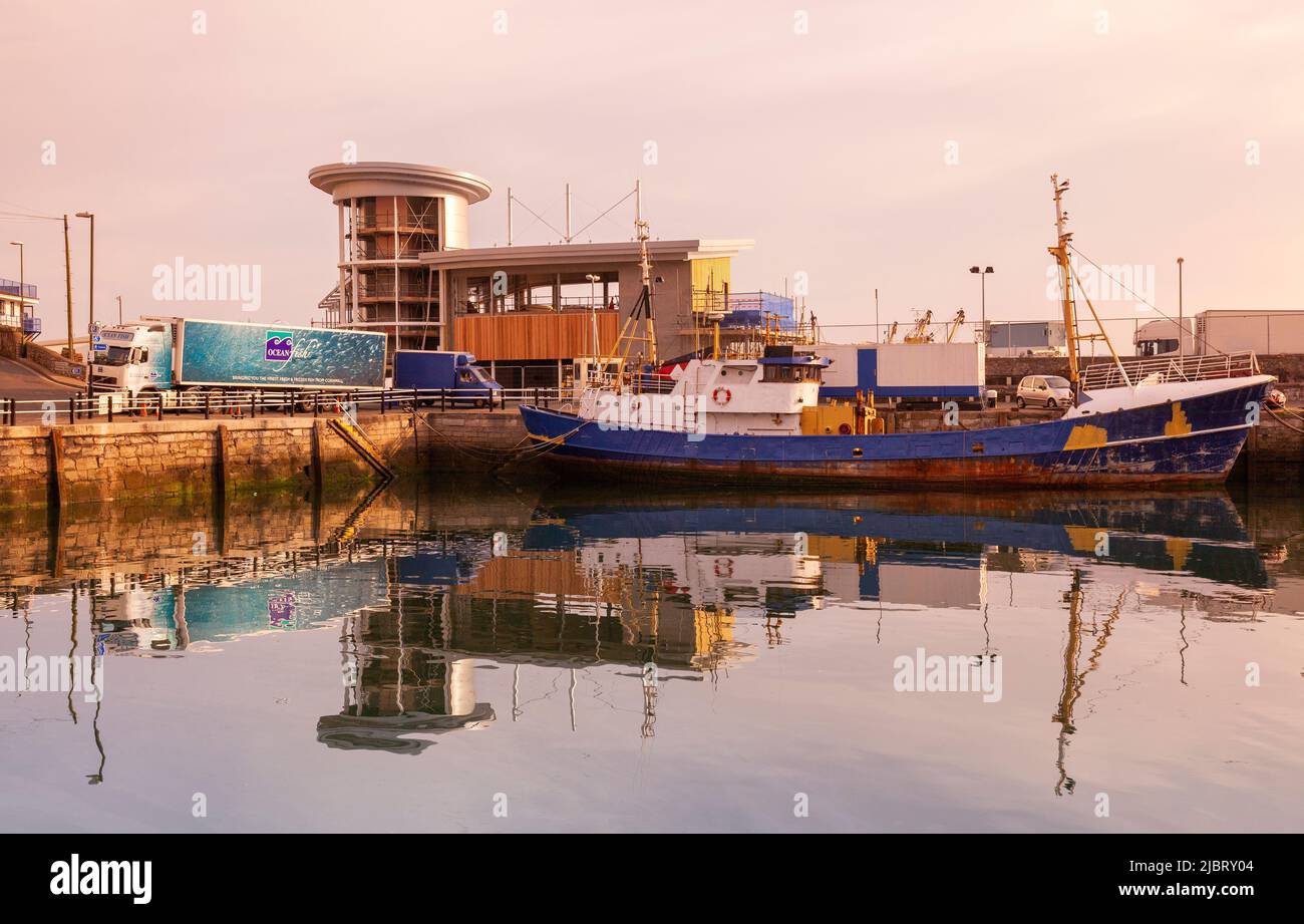 UK, England, Devon, Torbay, Brixham Harbour at Dawn with Trawler Moored at New Pier Stock Photo