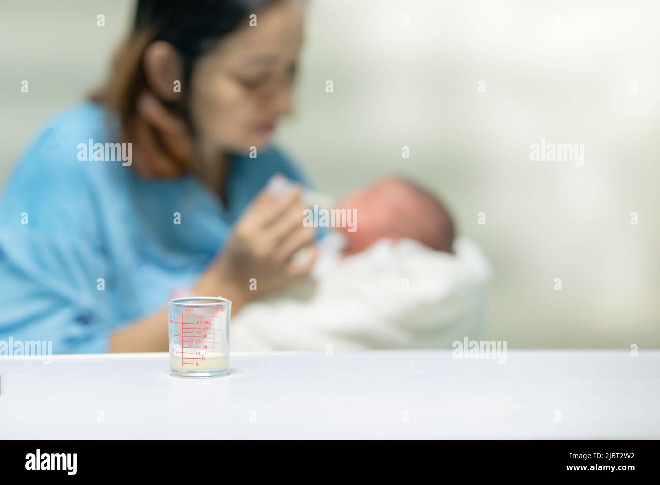 first breast milk after the birt with dropper,new born baby Breastfeeding from the first hour of birth , nursing in hospital Stock Photo