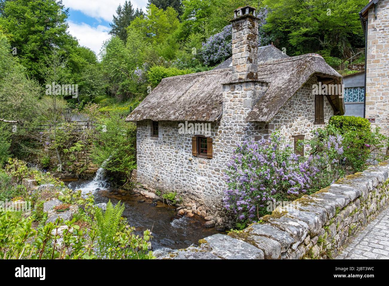 France, Correze, Gimel les Cascades, thatched cottage near the old bridge Stock Photo