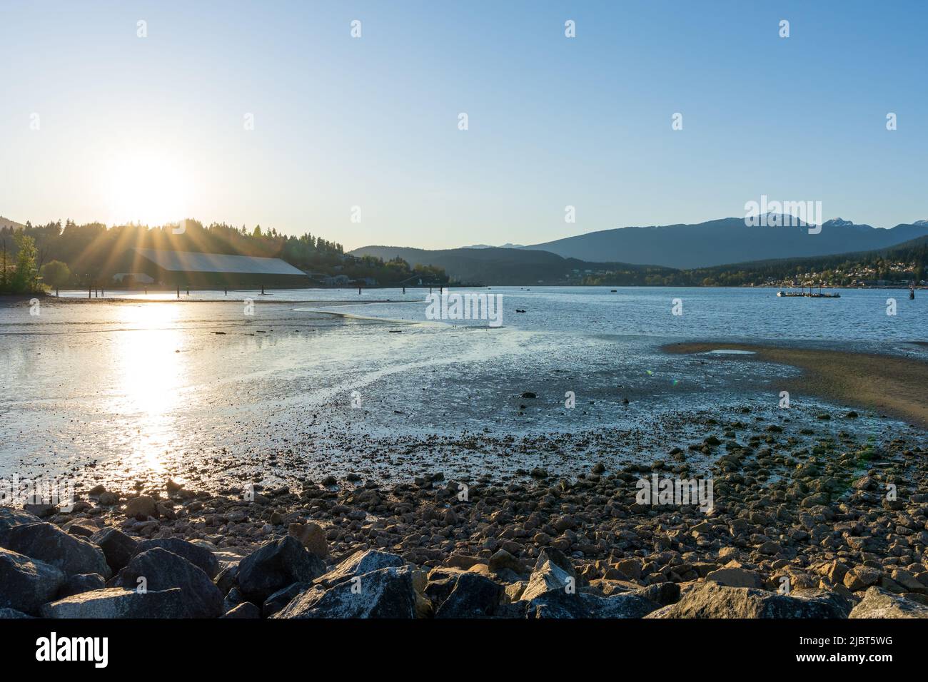 Burrard Inlet shore during sunset time. Rocky Point Park. Port Moody, British Columbia, Canada. Stock Photo