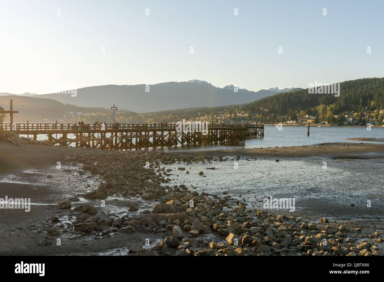 Rocky Point Park during sunset time. Long pier over the ocean. Port Moody, British Columbia, Canada. Stock Photo