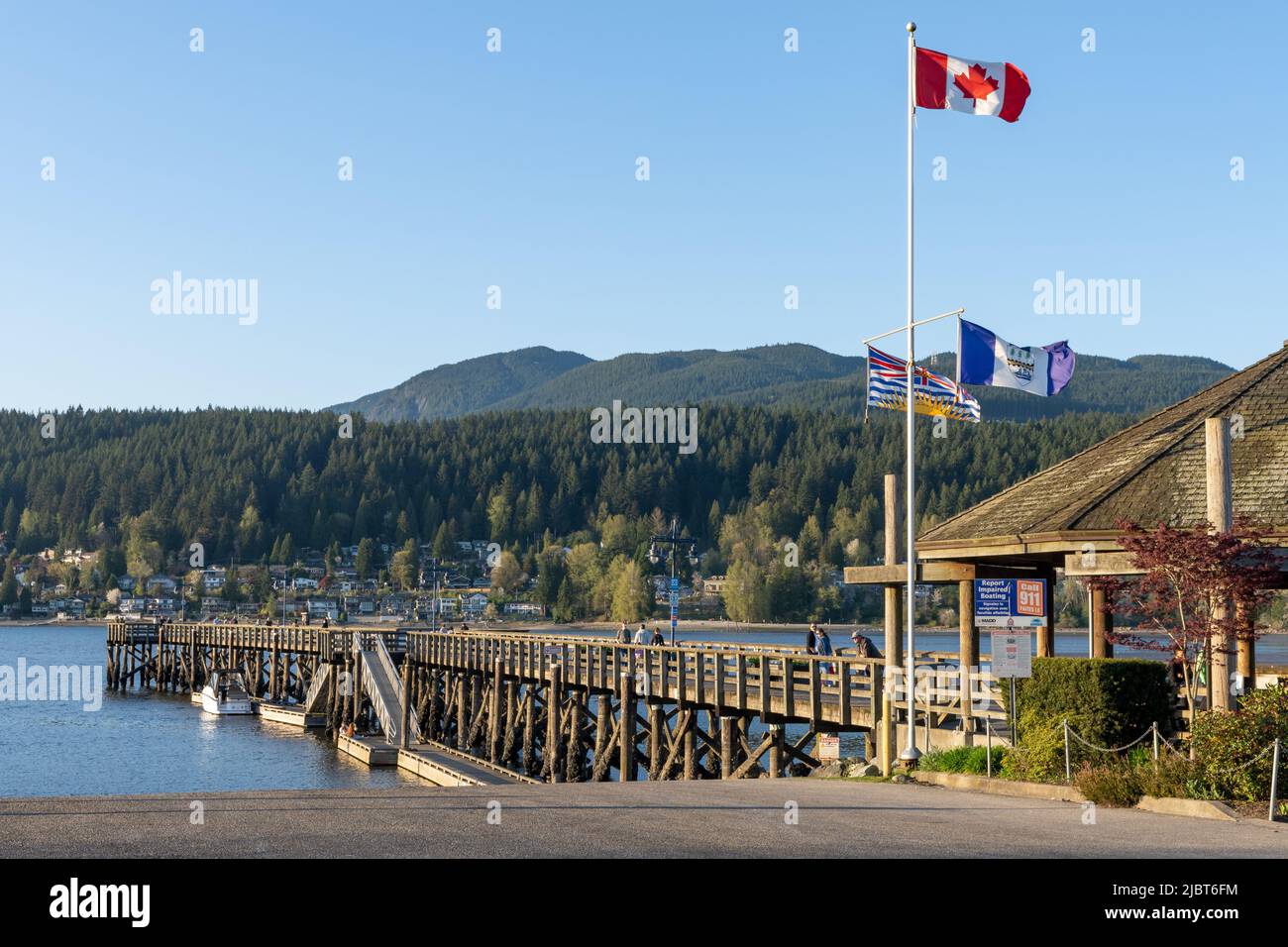 Rocky Point Park during sunset time. Long pier over the ocean. Port Moody, British Columbia, Canada. Stock Photo