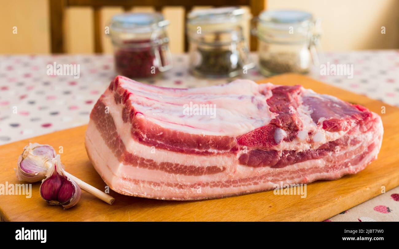 cooking traditional homemade lard with spices. pork belly with layer on