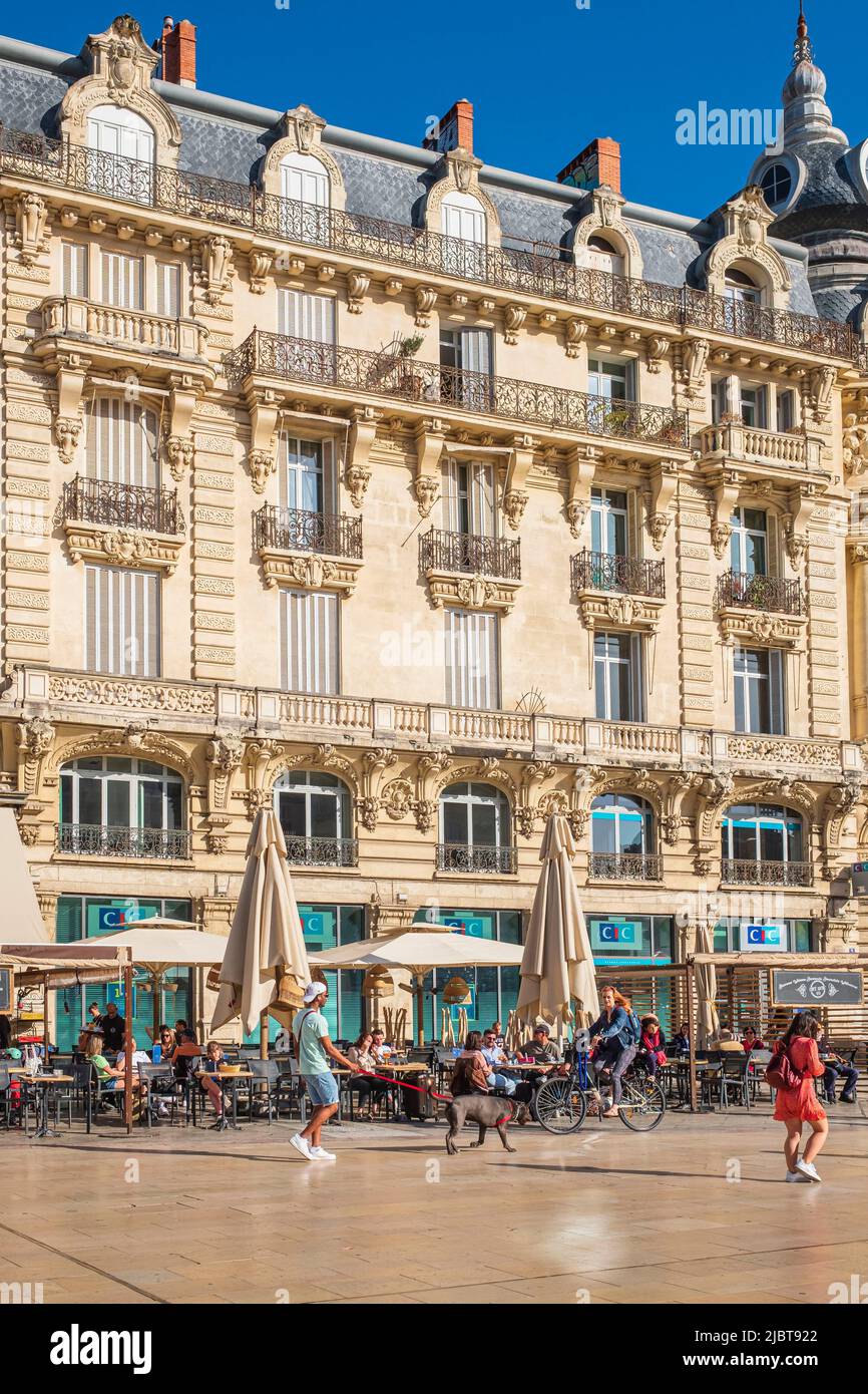 France, Herault, Montpellier, historic centre, Comédie square lined with 19th century Haussmannian buildings, the 1898 diver's building Stock Photo