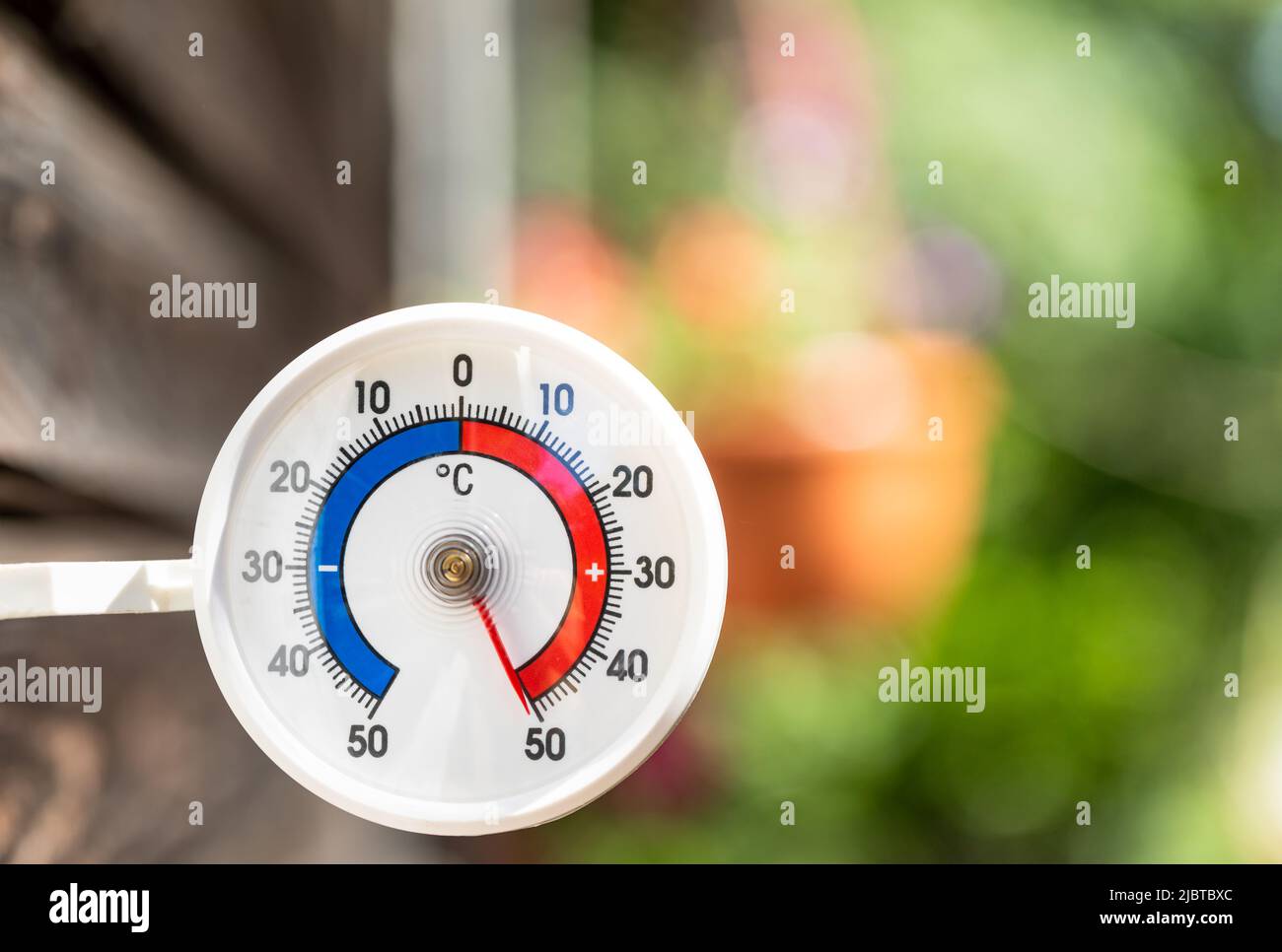 Outdoor thermometer with celsius scale shows extreme hot temperature 50 degree - summer heatwave concept Stock Photo