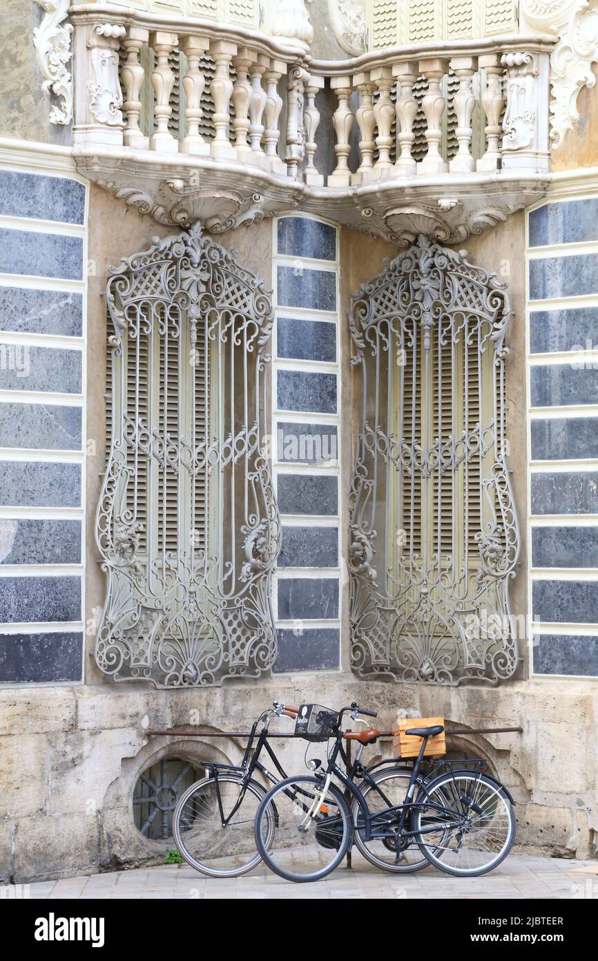 Spain, Valencia, bicycles placed against the facade of the Palace of the Marquis de Dos Aguas (baroque style) housing the national museum of ceramics González Martí Stock Photo