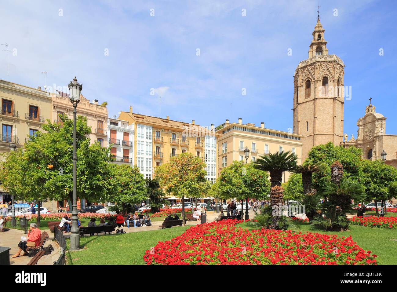 Spain, Valencia, Plaza de la Reina, geraniums with the bell tower of the Cathedral (Micalet) in the Gothic style (1381-1424) surmounted by an 18th century campanile in the background Stock Photo