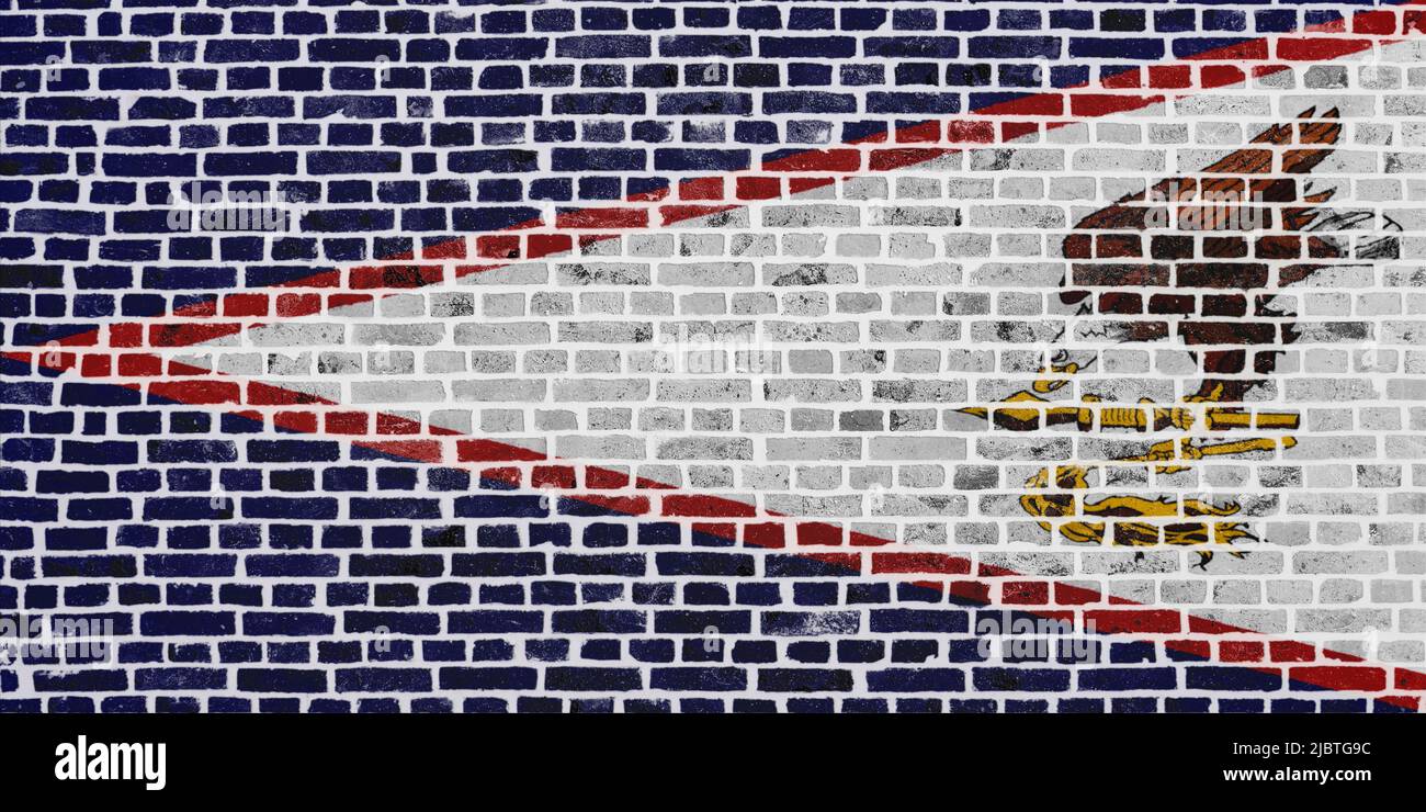 Close-up on a brick wall with the flag of the American Samoa painted on it. Stock Photo