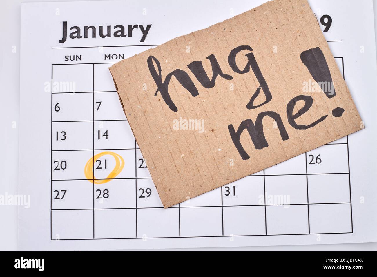Hug Calendar Hug day concept. Cardboard with hug me handwrititng on the calendar ...