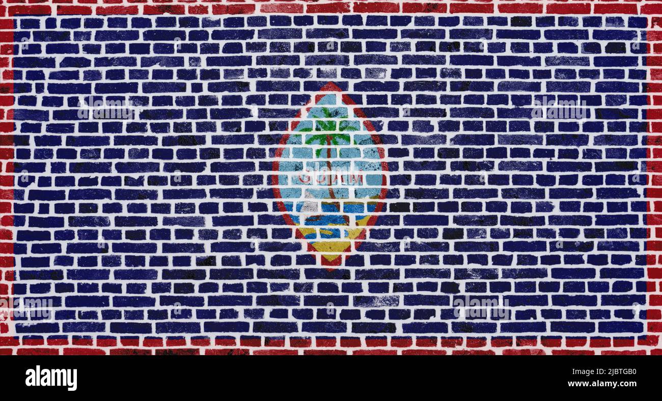 Close-up on a brick wall with the flag of Guam painted on it. Stock Photo