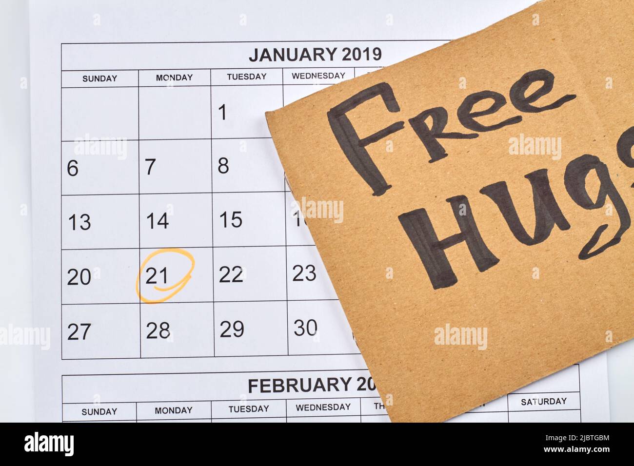 Free hugs day concept. Marked 21 day of january. Cardboard with ...