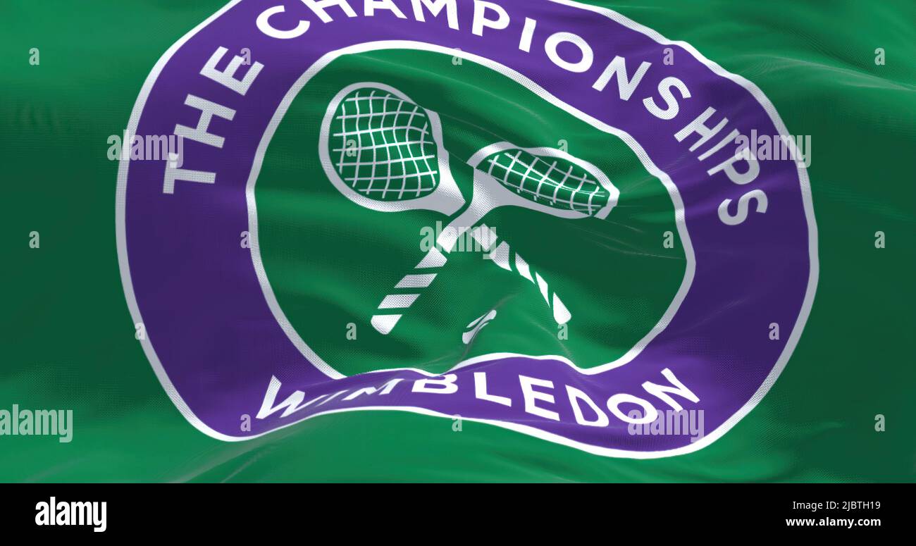 London, UK, April 2022: Close up of The Championships Wimbledon flag waving in the wind. Wimbledon Championships is a major tennis tournament schedule Stock Photo