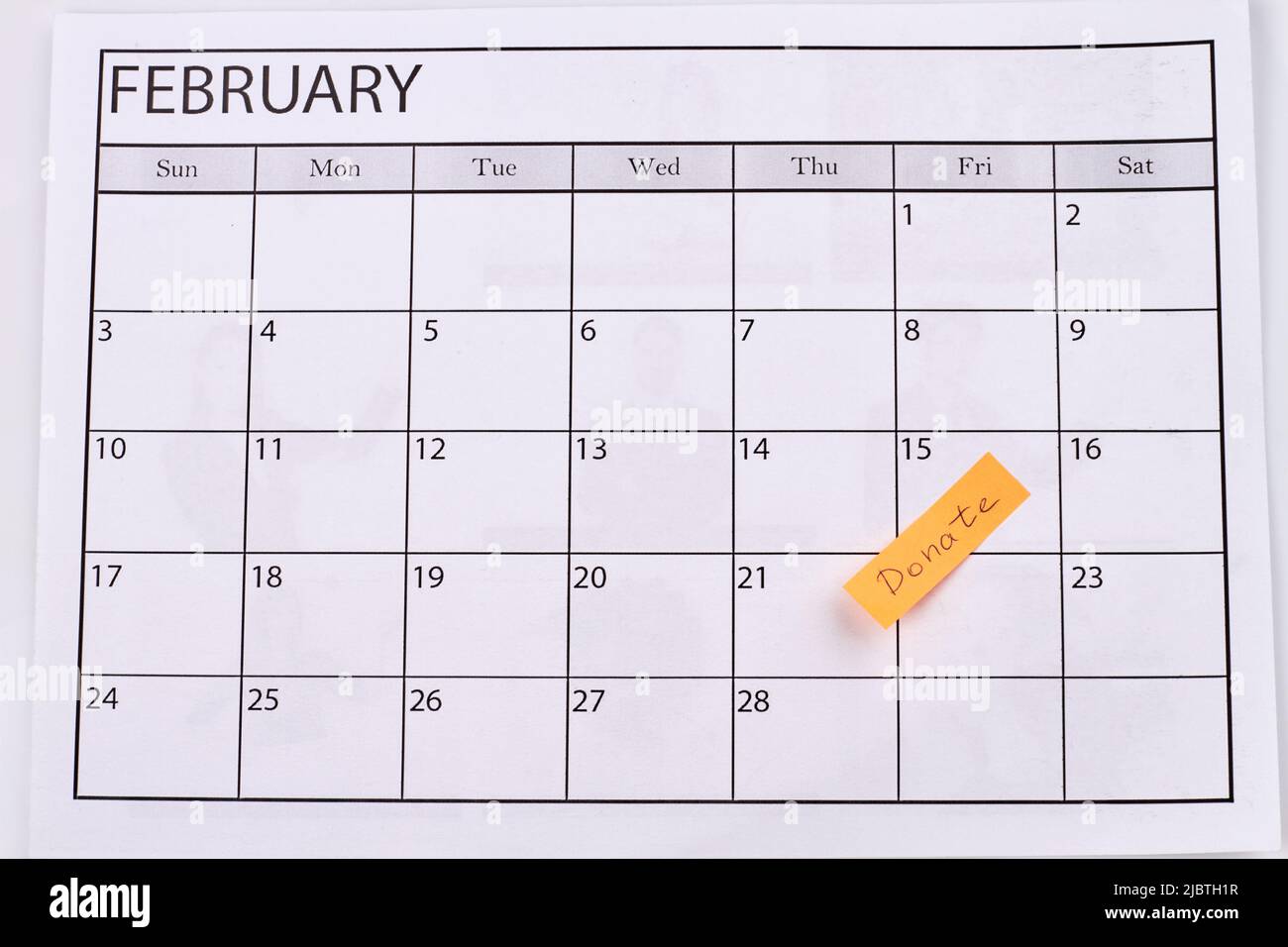 Donate day concept. Paper calendar for february. Top view flat lay