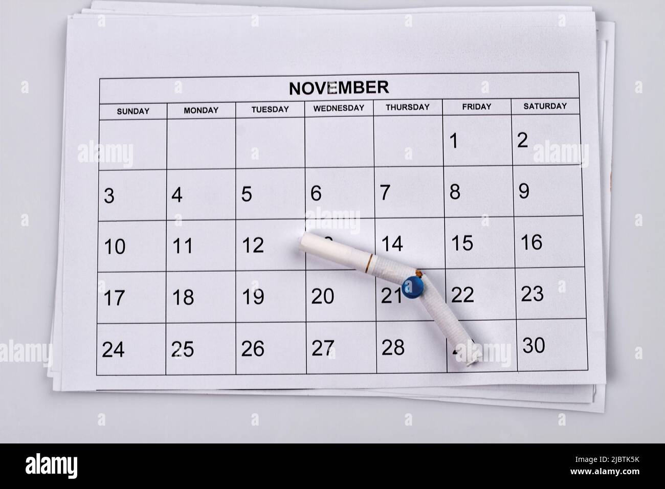 No smoking day in 21 of november. White month calendar. Broken cigarette on the push pin. Stock Photo