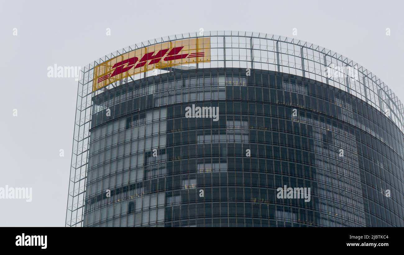 Bonn, Germany - Mar 30, 2022: Top of the Post Tower with DHL logo. The headquarter of Deutsche Post. Stock Photo