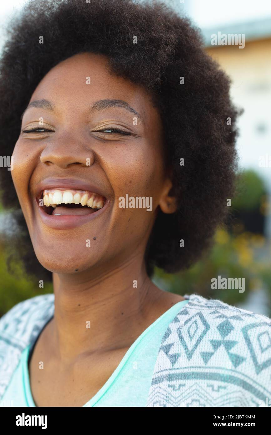 Close up portrait of african american woman smiling in the garden Stock Photo