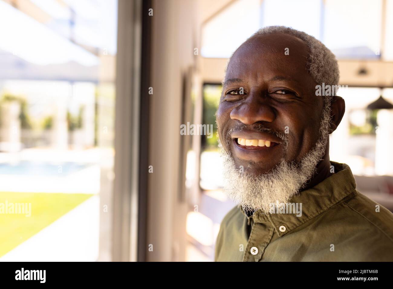 Close-up portrait of bearded smiling african american senior man in retirement home Stock Photo