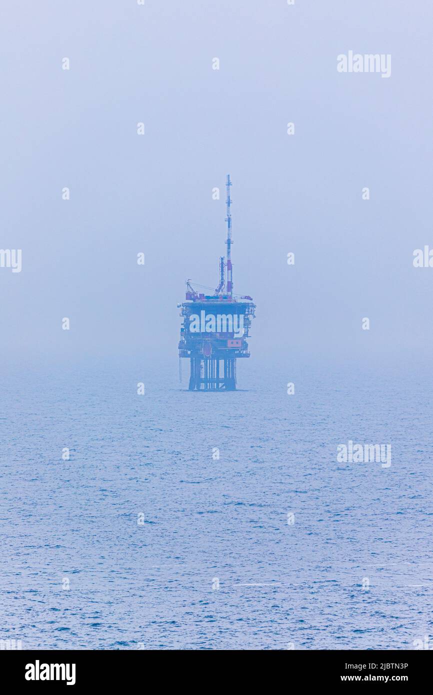 A misty view of an oil or gas platform in the North Sea halfway between Essex and The Netherlands Stock Photo