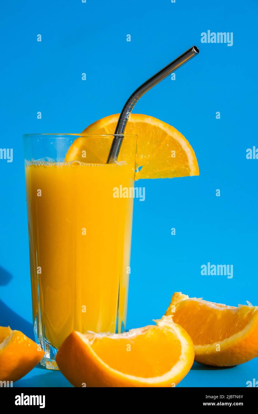 Glass of fresh squeezing Orange juice with eco metal drinking straw